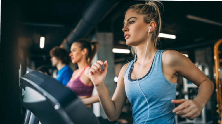A person running on a treadmill in the gym.